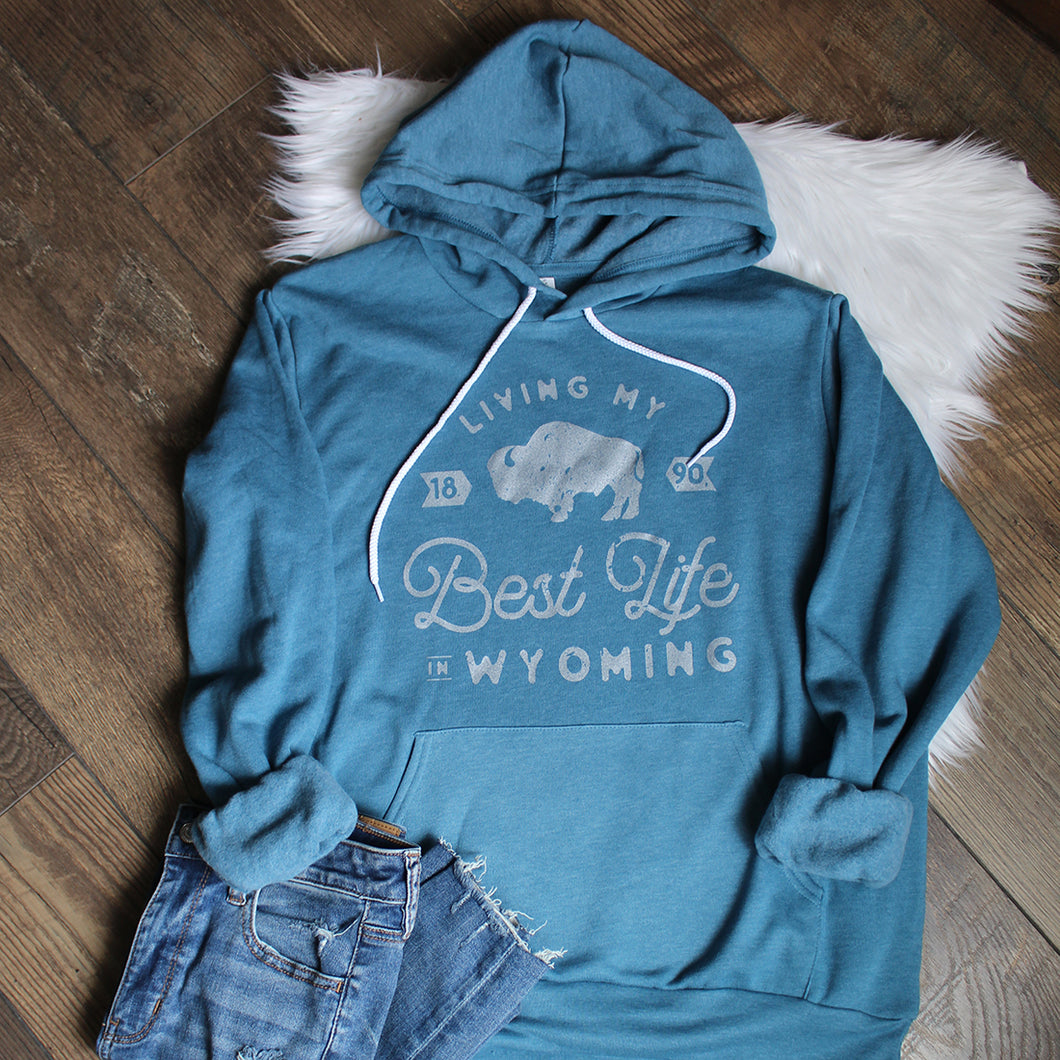Living My Best Life in Wyoming Hooded Sweatshirt in Heather Teal